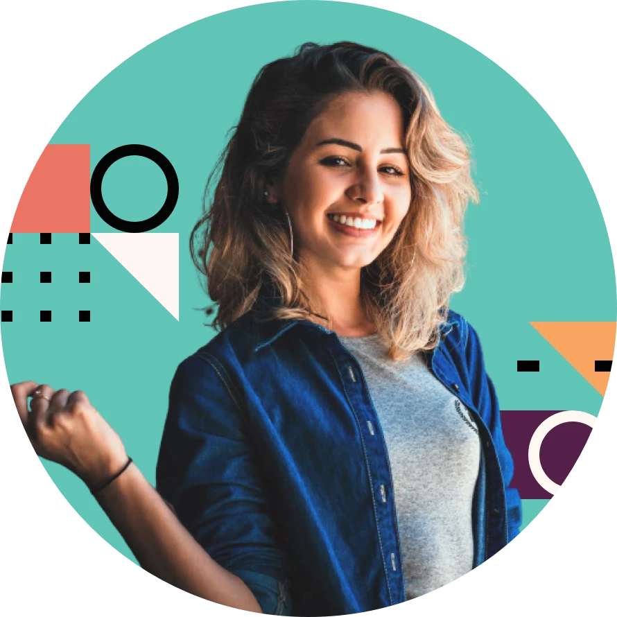 A white blode girl smilling. She is wearing a blue jacket and a gray shirt