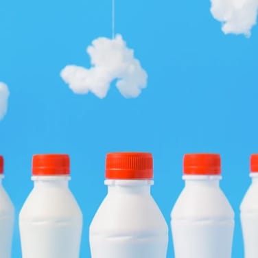 three bottles of milk with background sky