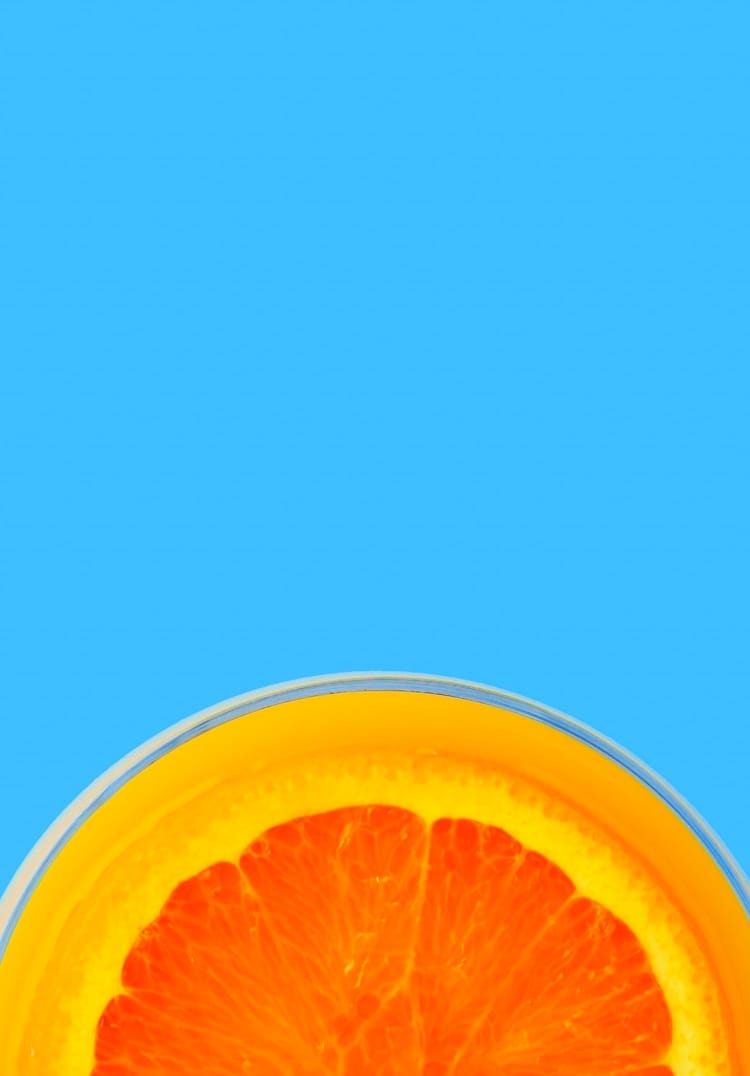 one slice of orange with backgroud color blue